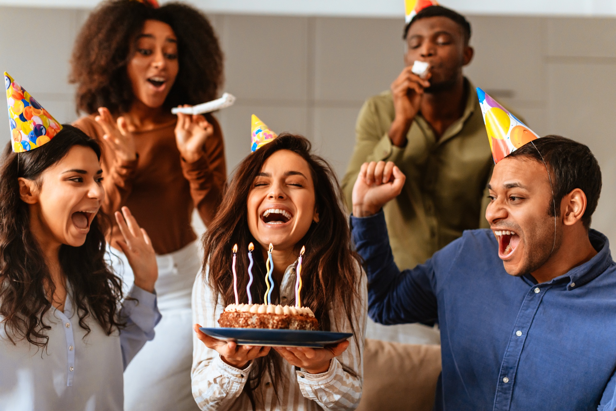 Group singing birthday song to a friend